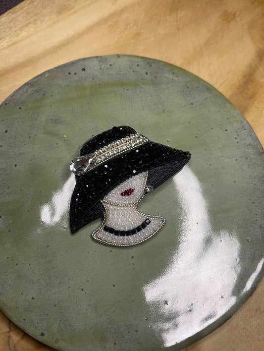 Brooch Lady in a black hat